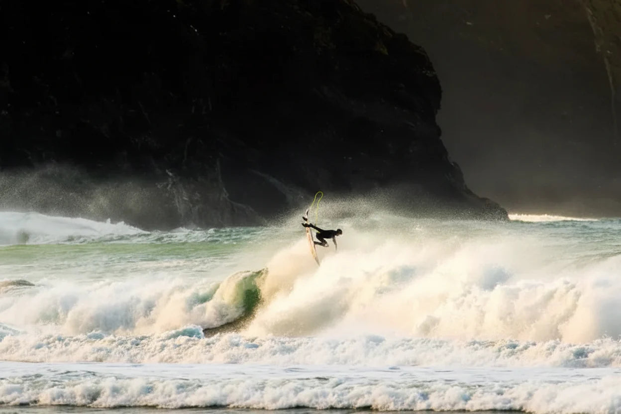 Surfer performing an 'off-the-lip' manoeuvre on a wave.