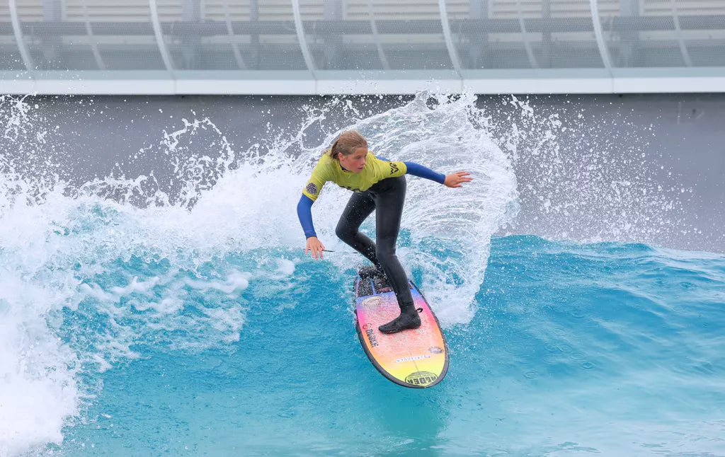 Surfer performing an 'off-the-lip' manoeuvre on a wave.