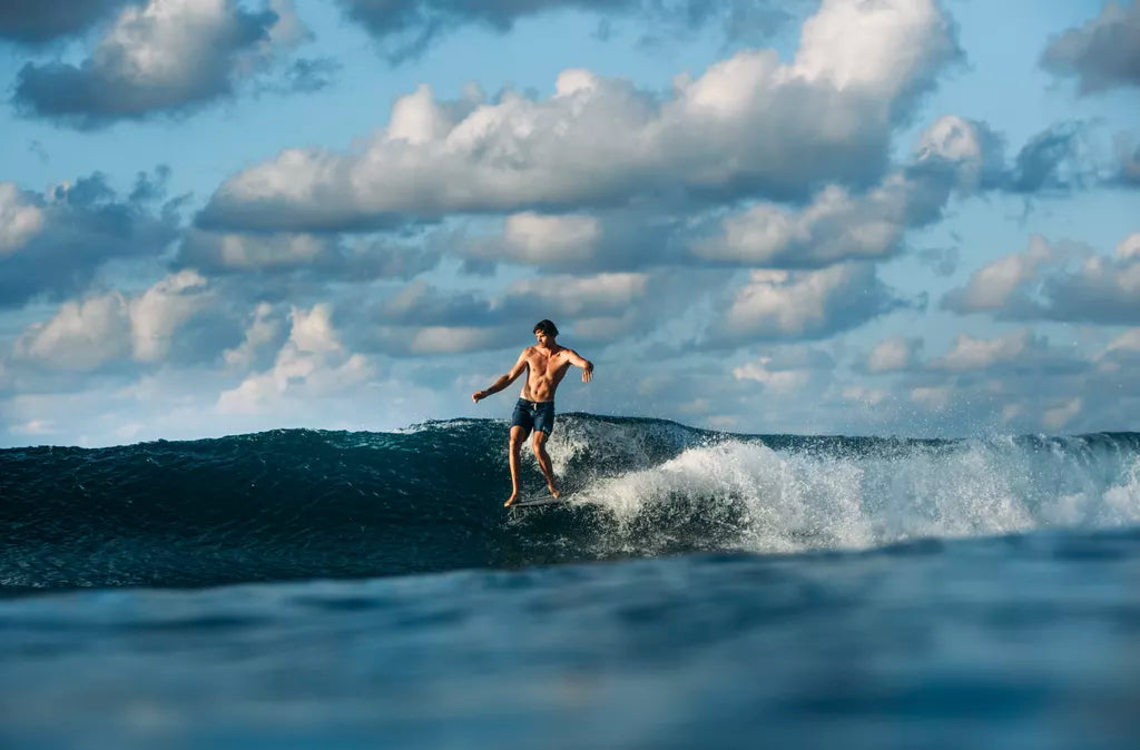 Surfer performing an 'off-the-lip' manoeuvre on a wave.