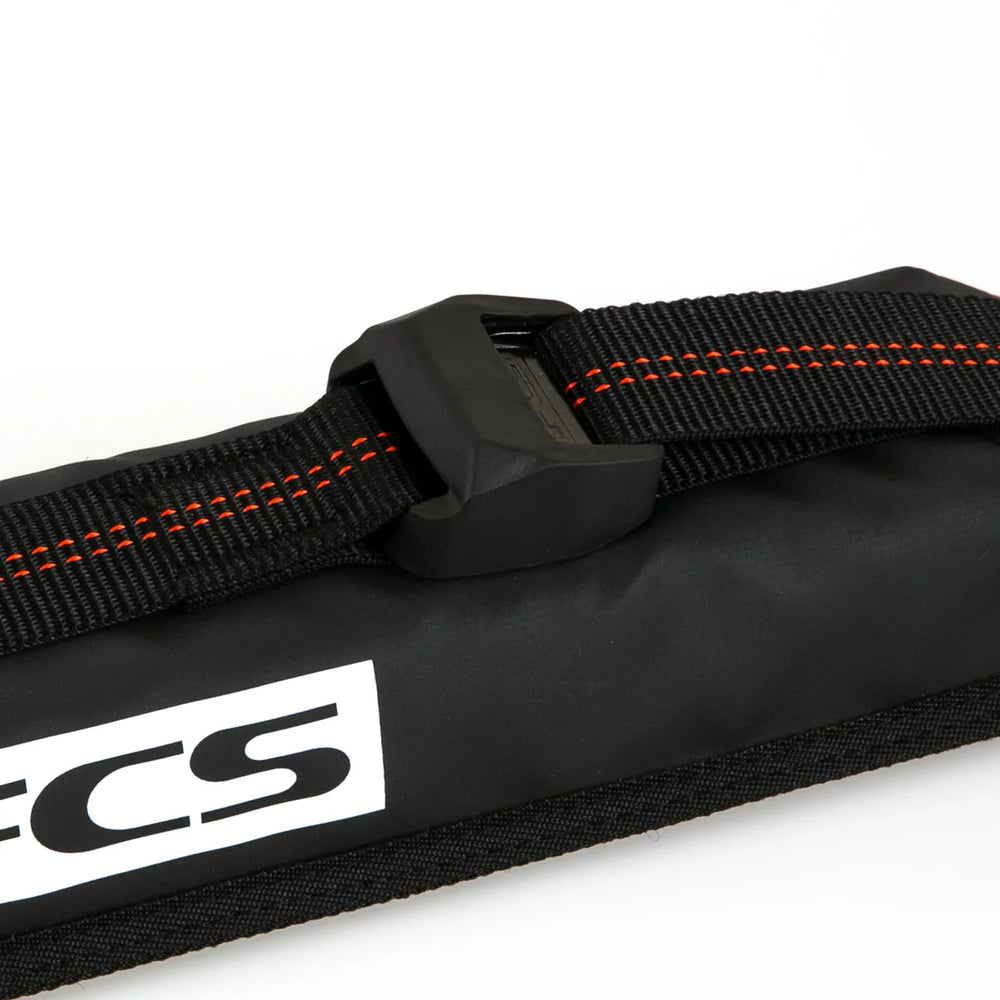 Black strap with orange stitching and FCS logo on a white background