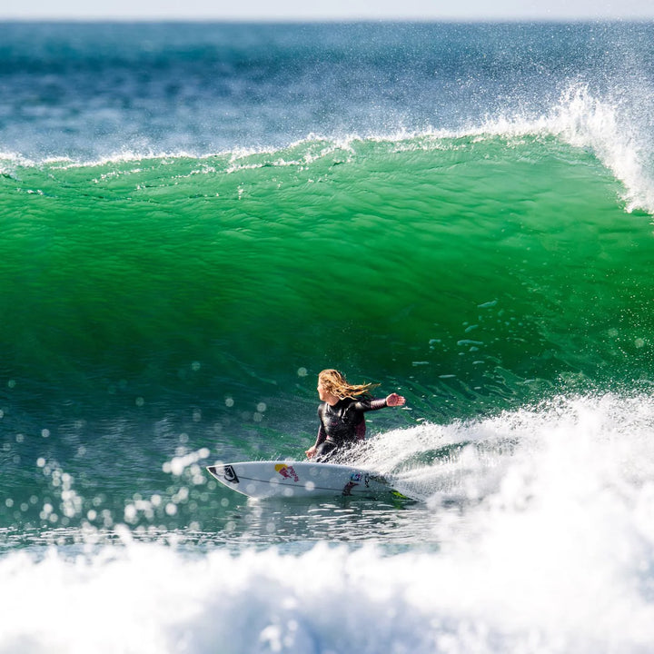 Person surfing on a wave in the ocean