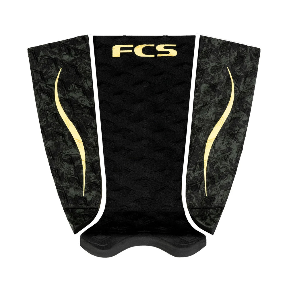 Black and gold FCS surfboard tailpad on a white background