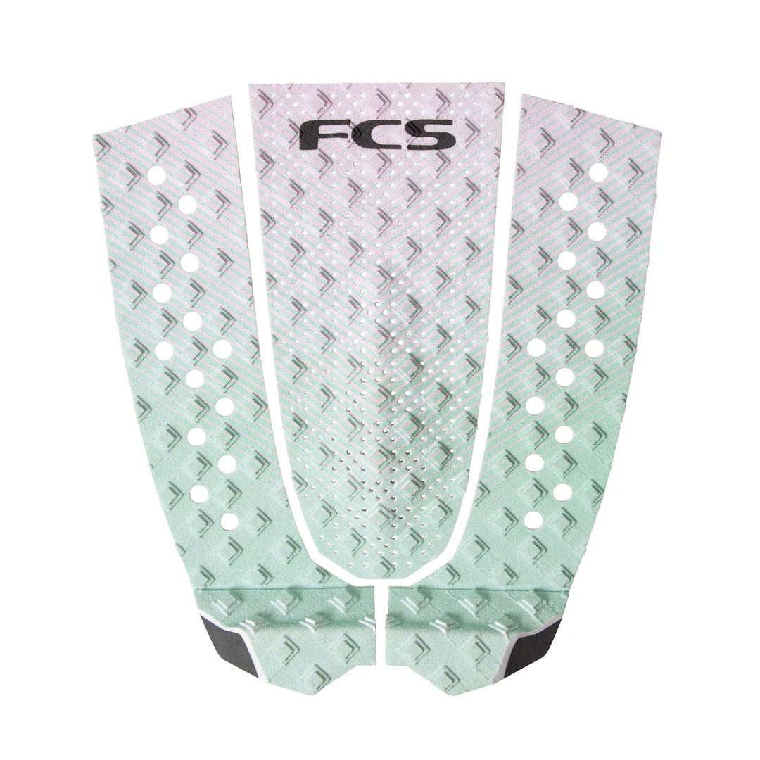 FCS branded surfboard tail pad with geometric pattern on a white background