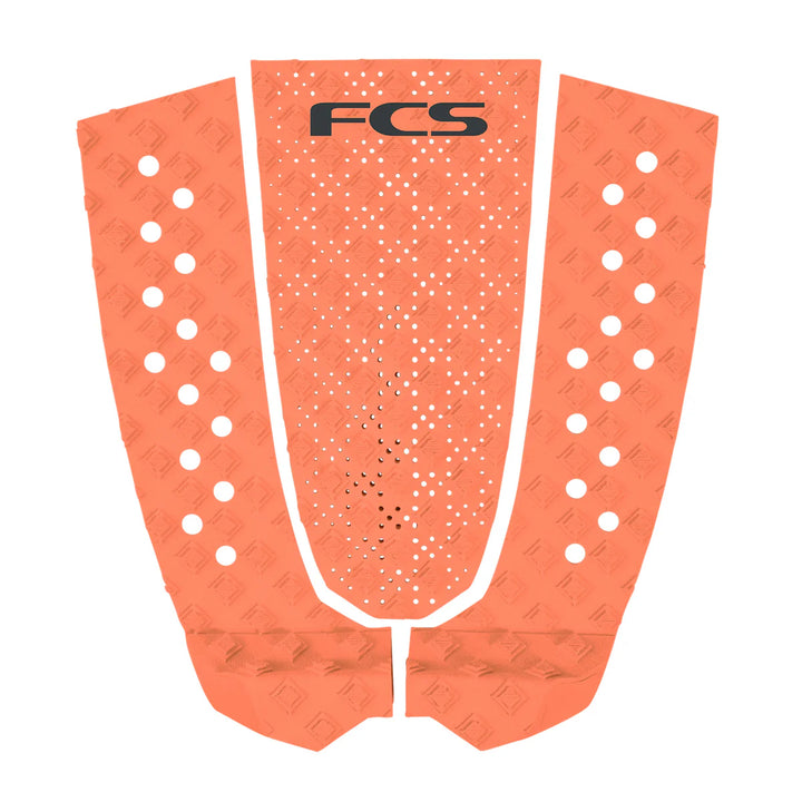 Orange FCS surfboard tail pad on a white background.