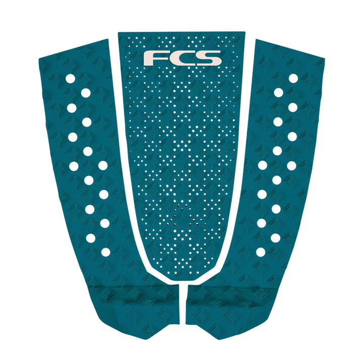 Teal FCS surfboard tail pad with white dots on a white background