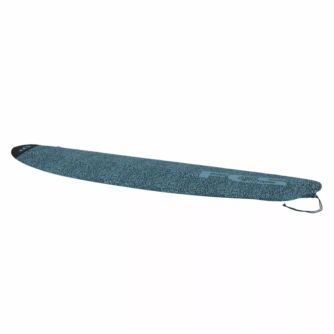 Blue textured FCS surfboard bag on a white background