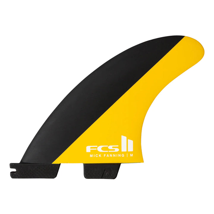 Black and yellow surf fin with FCS logo on a white background
