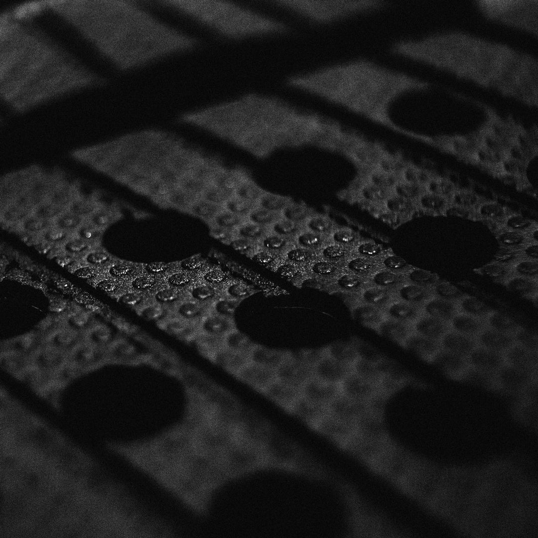 Close-up of a textured black tail pad with patterns