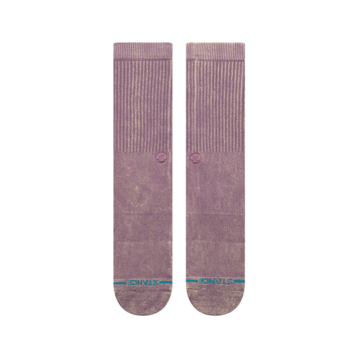 A pair of plum-coloured crew socks laid flat, showing a blue STANCE logo across the toes .