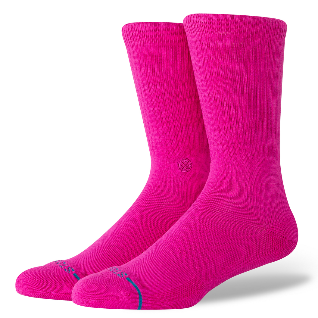 A pair of bright pink crew socks with a small blue accent line near the toes, displayed on a clean white background.