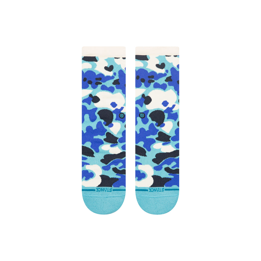 A pair of Stance crew socks with a blue, light blue, white, and black camouflage pattern, featuring a light blue toe and heel and the Stance brand name printed on the sole.