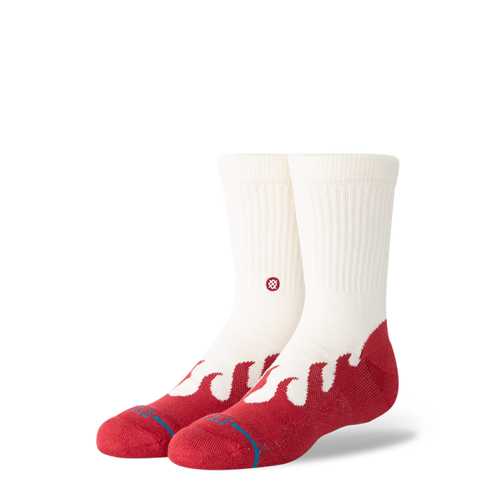 A pair of Stance crew socks in off-white and red, featuring a wavy red pattern on the lower half and a small red circular logo on the side, set against a plain white background.