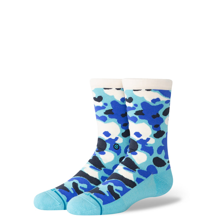 A pair of kids socks with a blue, white and black camouflage design on a white background.