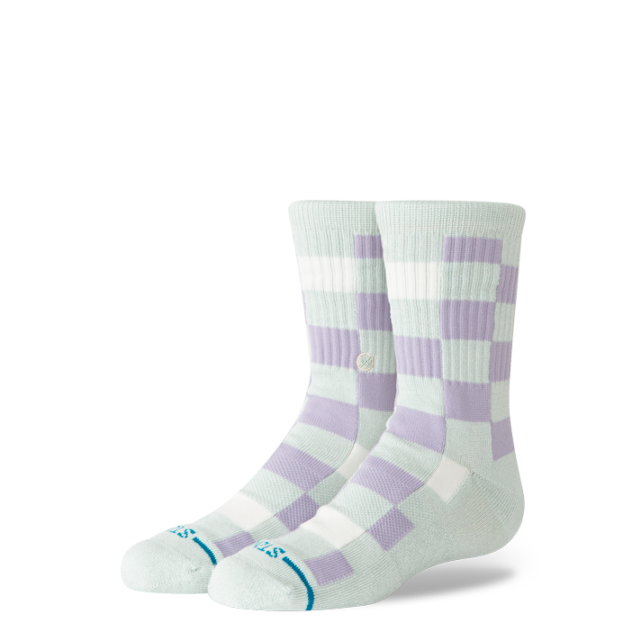 A pair of crew socks with a light green base and lavender purple checkerboard pattern, featuring a small blue logo on the toes.