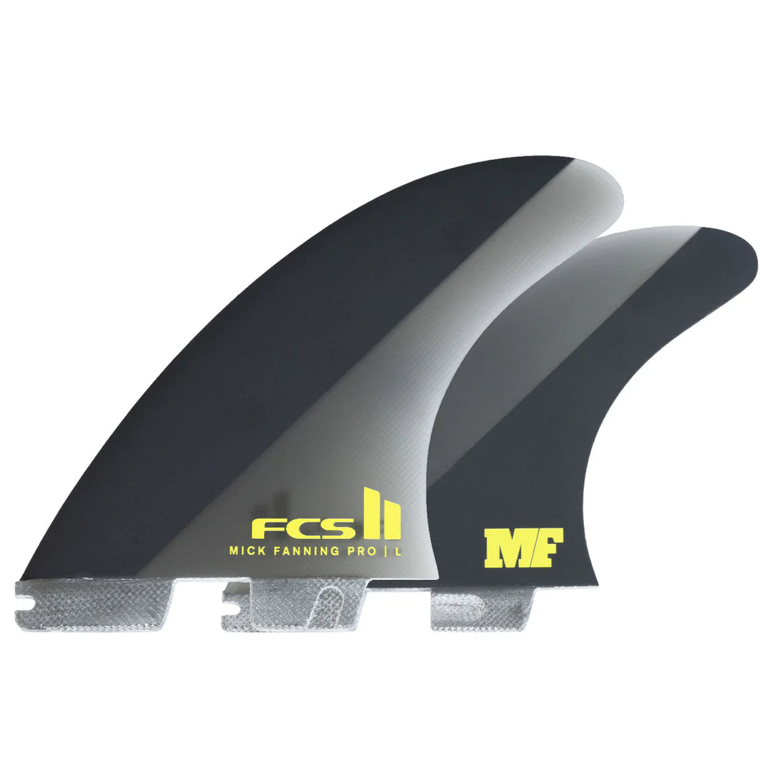 Two surfboard fins with FCS II and Mick Fanning branding on a white background
