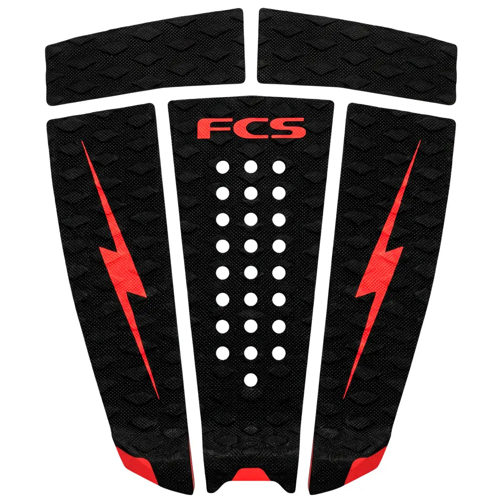 Black and red FCS surfboard tail pad with lightning bolt design on a white background