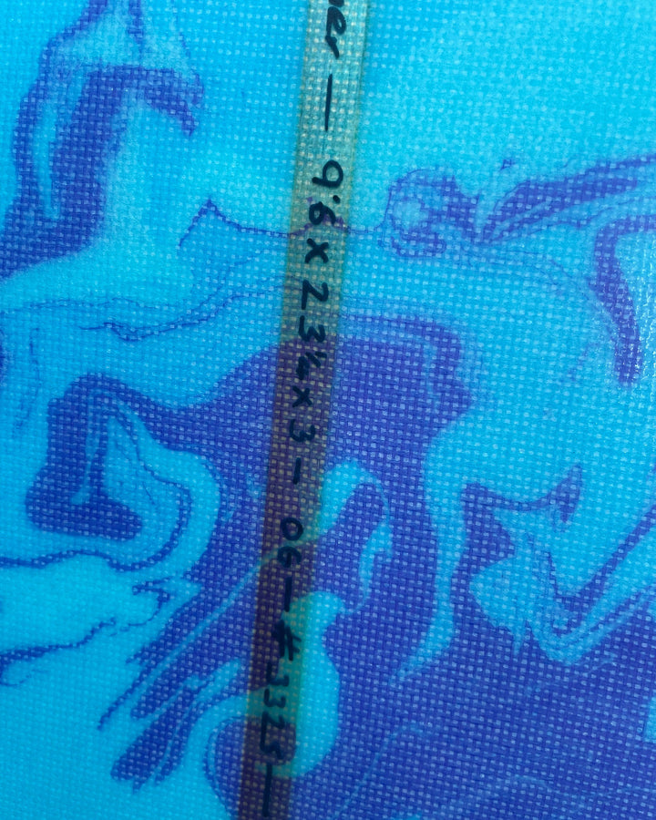 Measurement written on a blue surfboard with a pattern