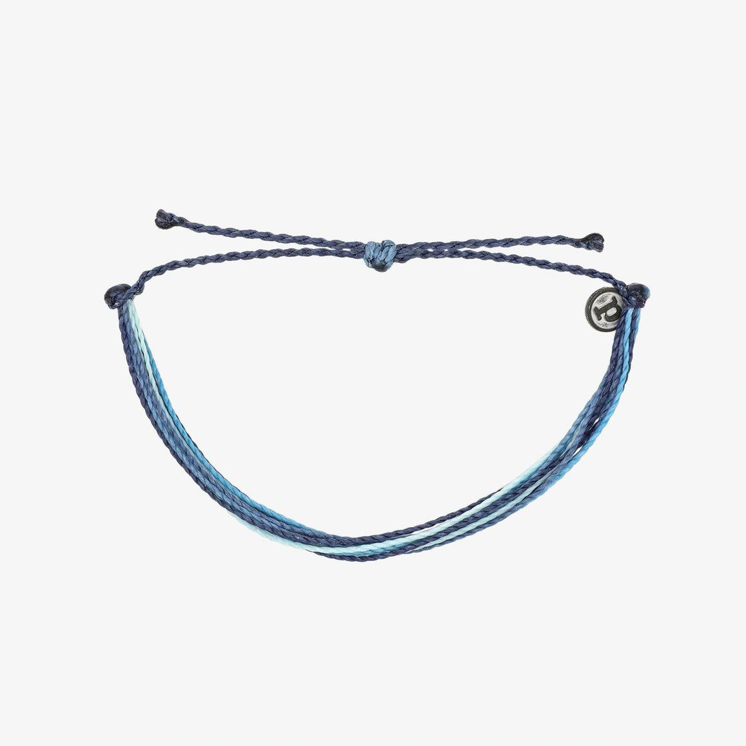 Bracelet made of blue threads on a white background
