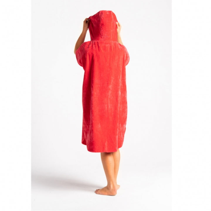 Person wearing a red hooded towel on a white background