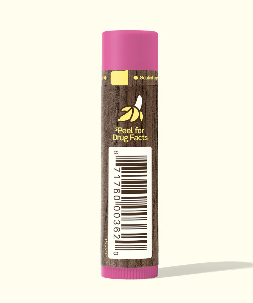 Lip balm with a pink cap and brown body on a white background