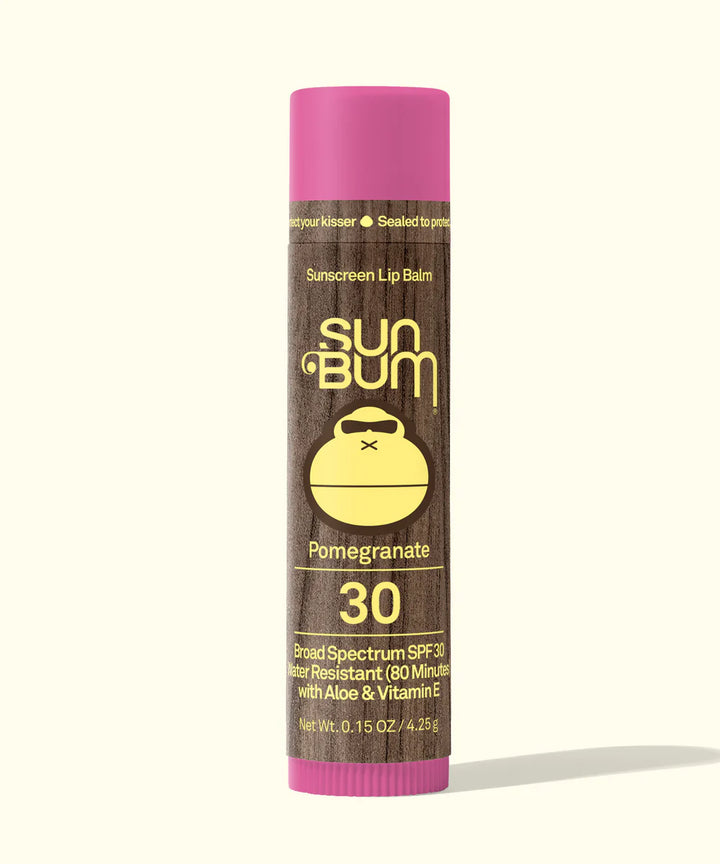 Sun Bum lip balm with pink cap and brown label on a white background