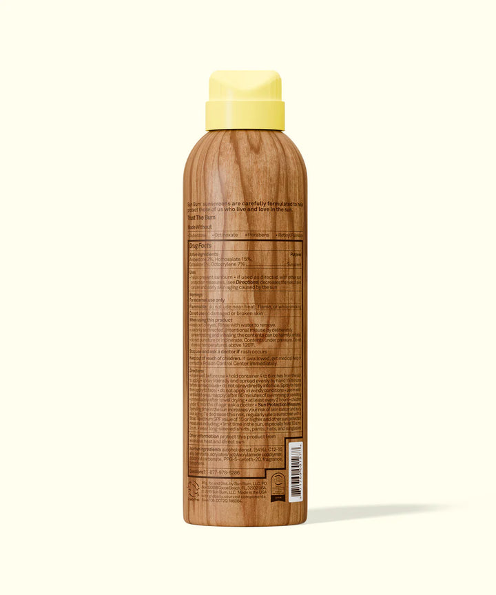 Wooden bottle with a yellow cap on a white background