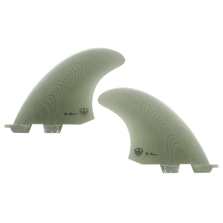 Two light green coloured surfboard fins, signed by Ben Skinner, on a white background