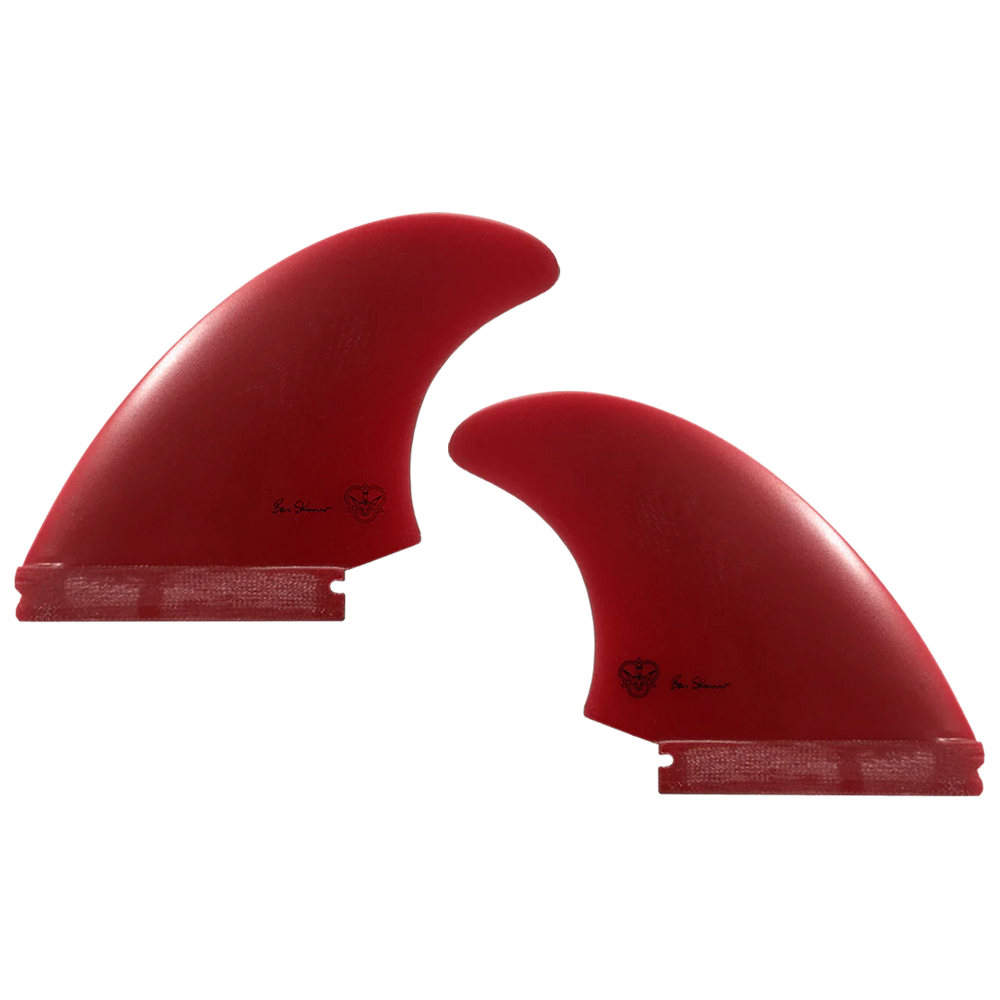 Two red surfboard fins, signed by Ben Skinner, on a white background