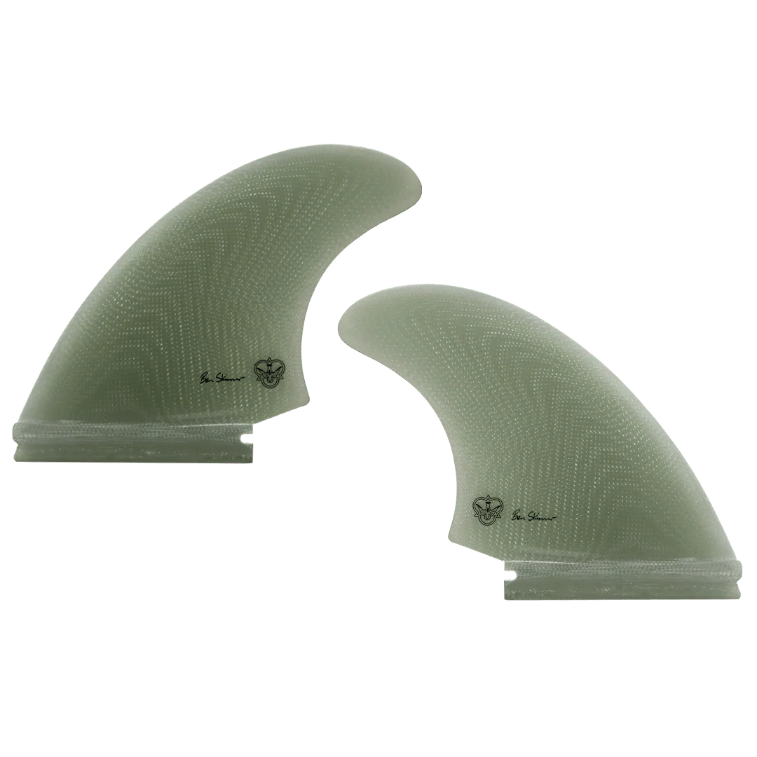 Two green surfboard fins, signed by Ben Skinner, on a white background