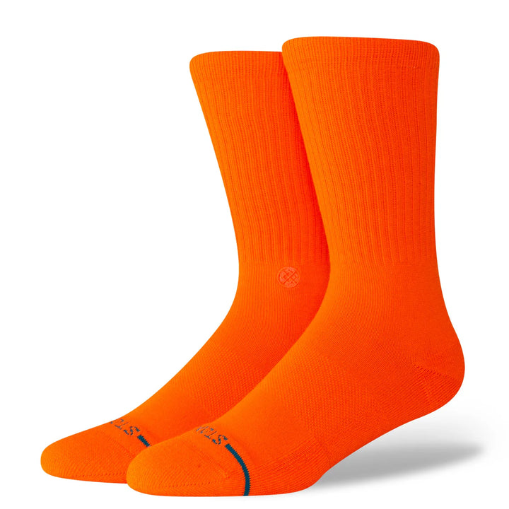 Two bright orange socks with a brand logo on a white background