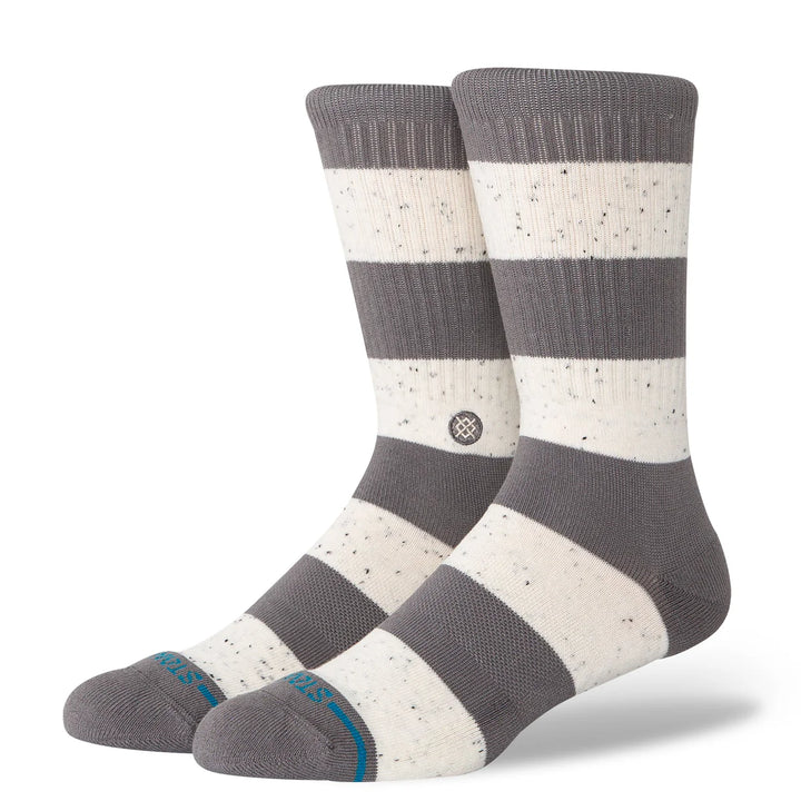 Pair of gray and white striped socks with a visible brand logo on a white background
