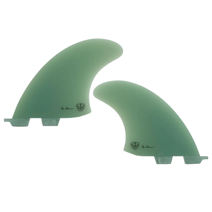 Two green surfboard fins, signed by Ben Skinner, on a white background
