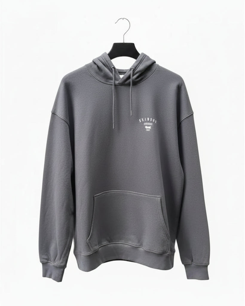 Dark grey hoodie with a Skindog Surfboards brand chest logo on a white background