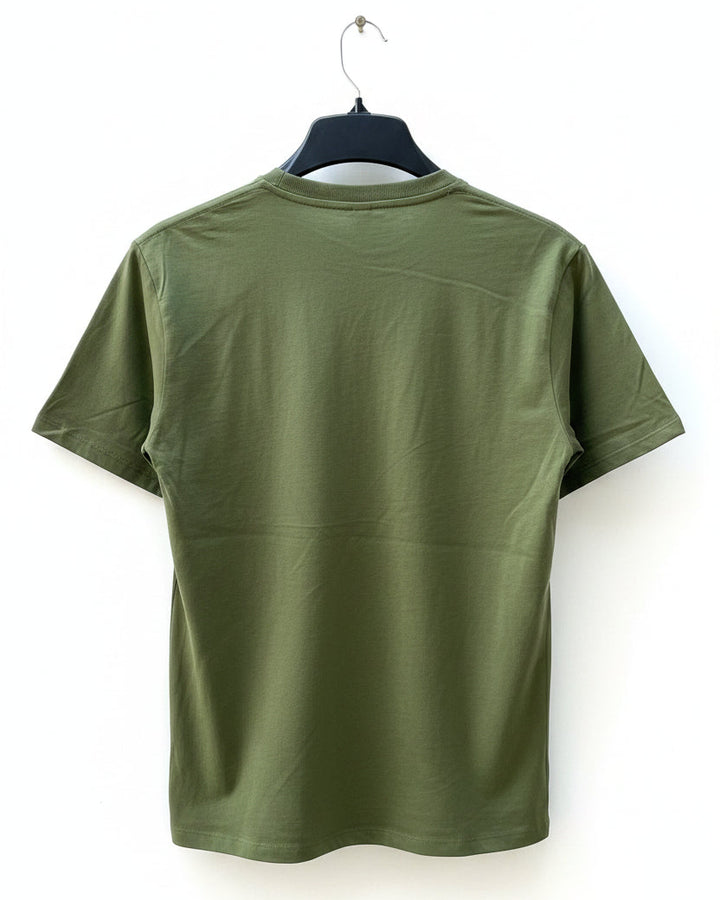 Green t-shirt on a black hanger on a white background.