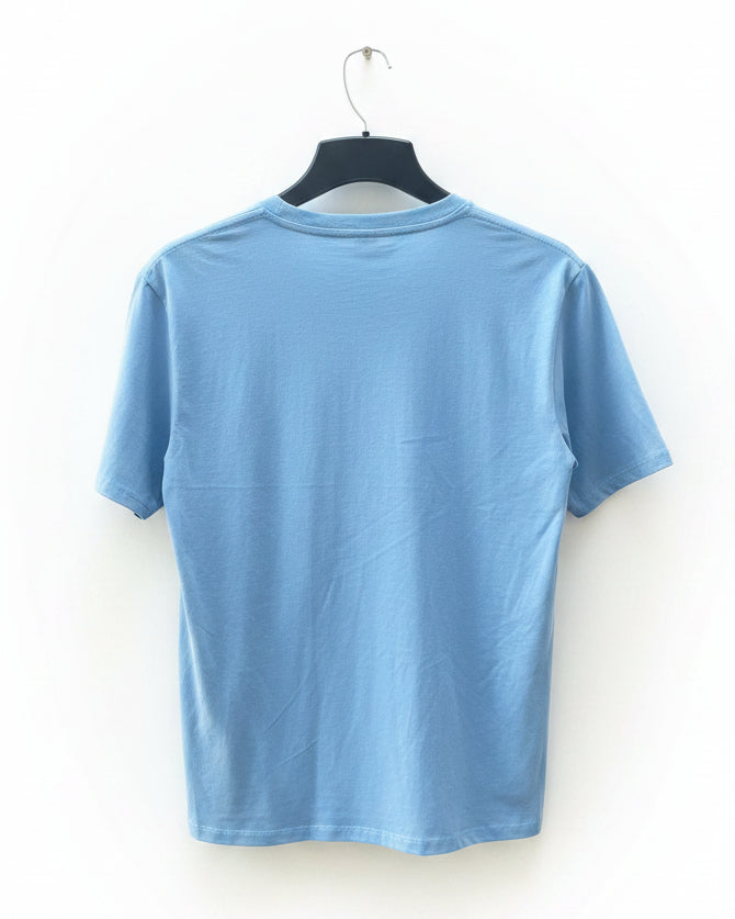 A light blue short-sleeve crewneck t-shirt hanging on a black hanger against a white background.