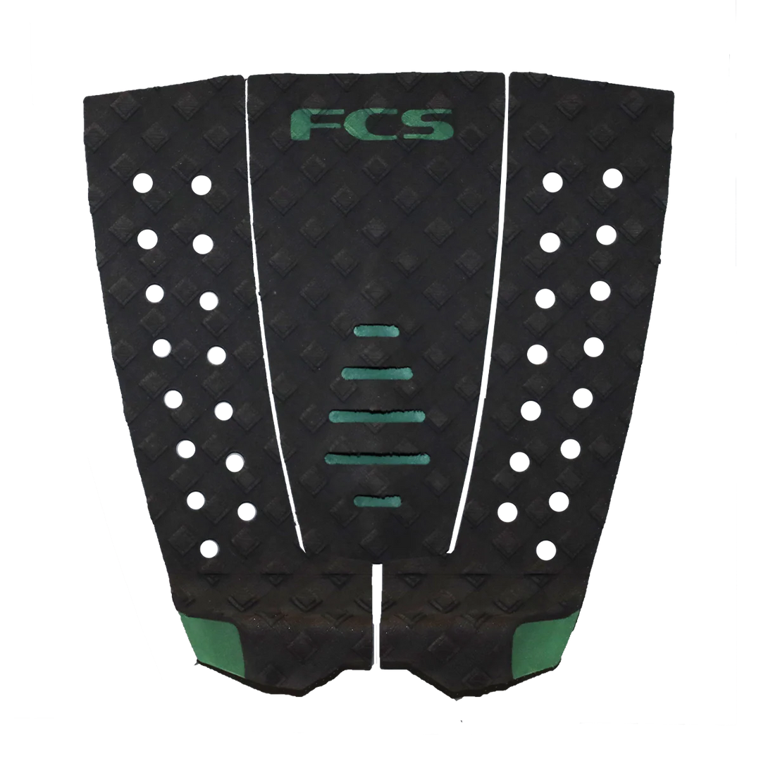 Black and green FCS surfboard tail pad on a white background