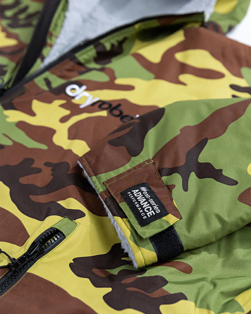 Close-up of a camouflage Dryrobe with visible brand logos on a white background