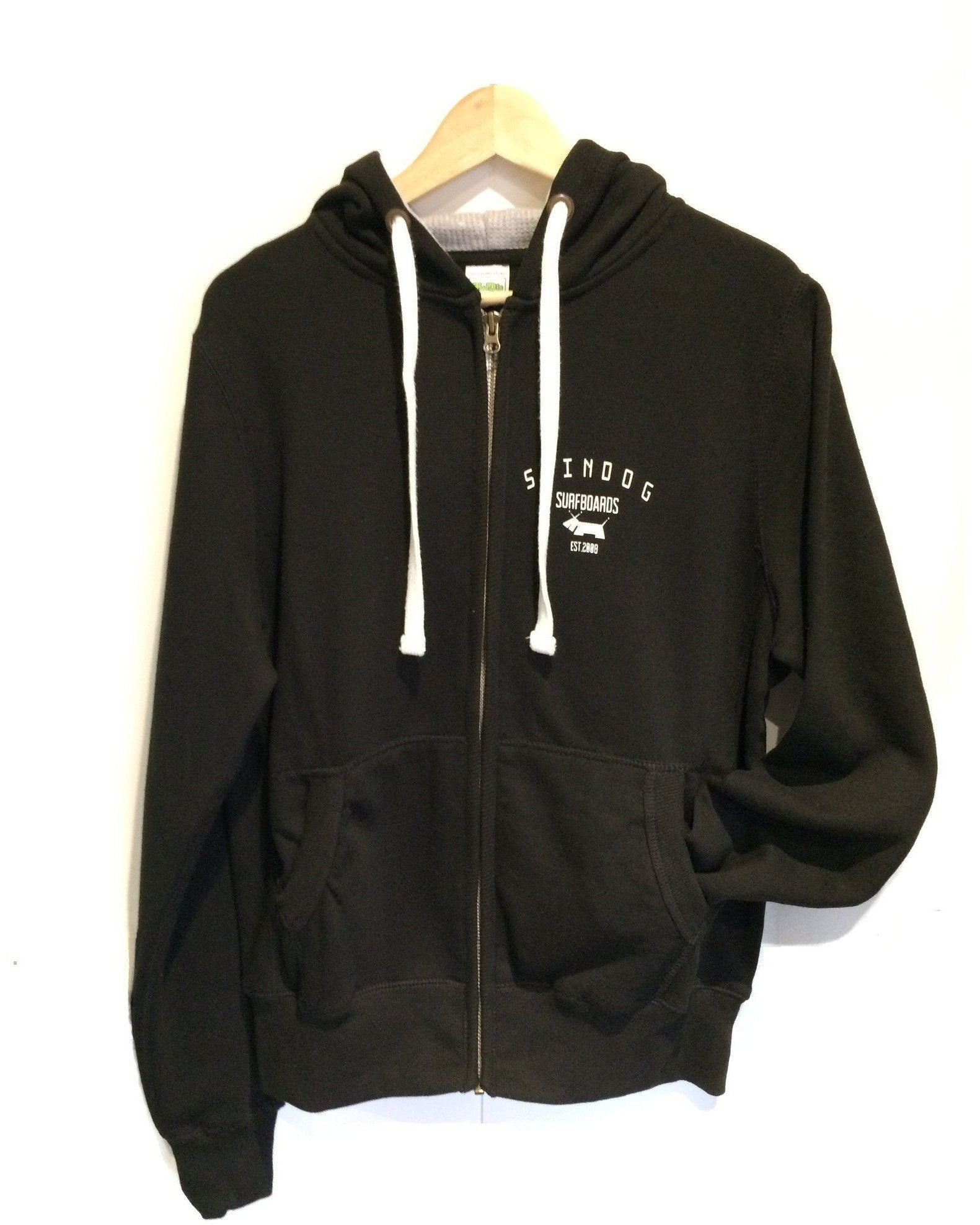 SKINDOG Surfboards zipped hoodie in black with white hood tassels on a white background